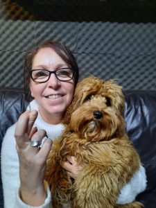 People Manager, Amanda, with her dog Leo sitting on her knee.